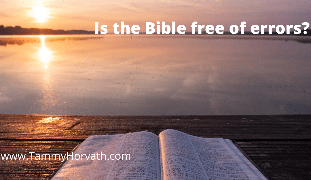 Bible on table on beach for blog post Is the Bible free of errors by Tammy Horvath