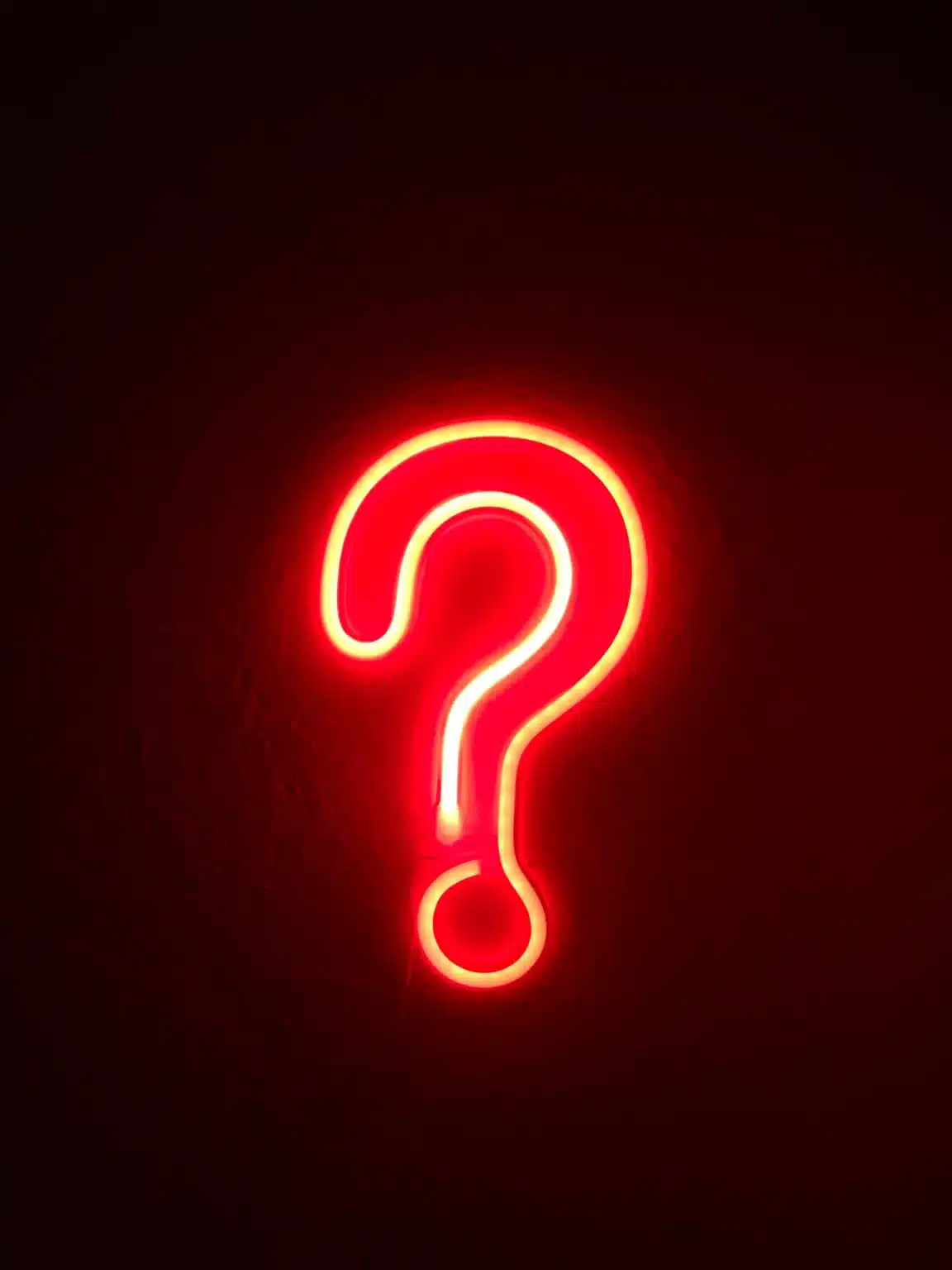 Picture of a red question mark on a black background