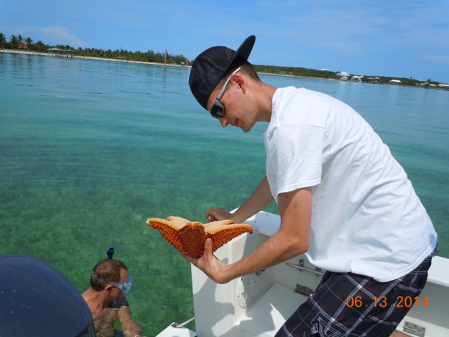 Luke Yuzwa looking at starfish before putting back in ocean in Abaco, Bahamas Luke Yuzwa looking at starfish before putting back in ocean in Abaco, Bahamas